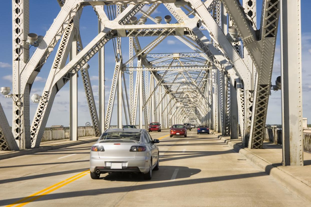 Traffic crossing an interstate highway four lane on a bridge over the Ohio River, Louisville, Kentucky, USA.