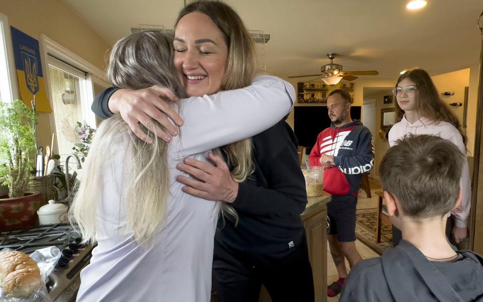 Yuliia Kurta hugs Cherie Phoenix. The Kurta family fled the war in Ukraine and is staying temporarily with Phoenix and her husband, John Longawa, in Thousand Oaks.