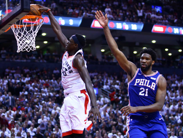 TORONTO, ON - MAY 07:  Pascal Siakam #43 of the Toronto Raptors dunks the ball as Joel Embiid #21 of the Philadelphia 76ers defends in the second half during Game Five of the second round of the 2019 NBA Playoffs at Scotiabank Arena on May 7, 2019 in Toronto, Canada.  NOTE TO USER: User expressly acknowledges and agrees that, by downloading and or using this photograph, User is consenting to the terms and conditions of the Getty Images License Agreement.  (Photo by Vaughn Ridley/Getty Images)