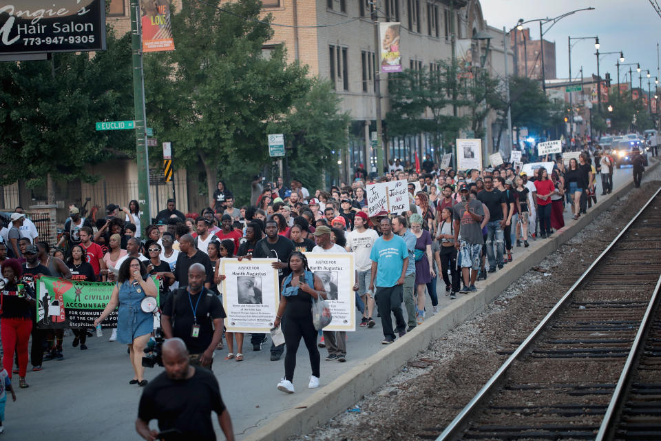<p>Demonstrators march through the South Shore neighborhood protesting the shooting death of 37-year-old Harith Augustus on July 16, 2018 in Chicago, Ill. (Photo: Scott Olson/Getty Images) </p>