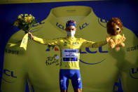 France's Julian Alaphilippe, wearing the overall leader's yellow jersey celebrates on podium after winning the second stage of the Tour de France cycling race over 186 kilometers (115,6 miles) with start and finish in Nice, southern France, Sunday, Aug. 30, 2020. (Stuart Franklin/Pool photo via AP)