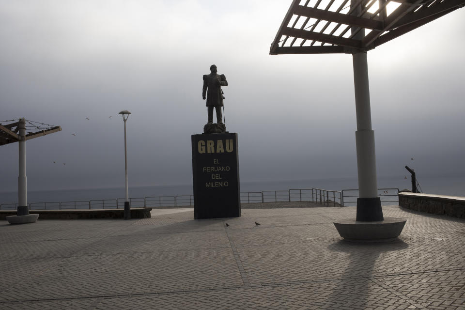 This March 25, 2020 photo shows a statue of Peruvian naval hero Miguel Grau overlooking the Pacific coast on the normally popular boardwalk usually filled with vistors, in Lima, Peru. The new coronavirus pandemic has changed all that. Peru's President Martín Vizcarra declared a state of emergency as deaths began to mount and ordered people to stay home. (AP Photo/Rodrigo Abd)