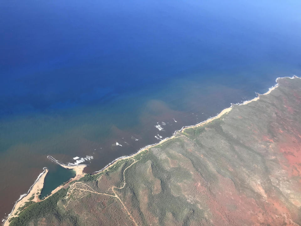 In this 2020 aerial photo provided by the Arizona State University's Global Airborne Observatory, runoff from the island of Molokai in Hawaii flows into the ocean. Recent flooding in Hawaii caused widespread and obvious damage. But extreme regional rain events that are predicted to become more common with global warming do not only wreak havoc on land, the runoff from these increasingly severe storms is also threatening Hawaii's coral reefs. (Global Airborne Observatory, Arizona State University via AP)