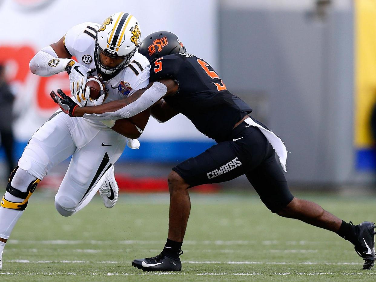 Kendall Blanton #11 of the Missouri Tigers is tackled by Kemah Siverand #5 of the Oklahoma State Cowboys during the first half of the AutoZone Liberty Bowl at Liberty Bowl Memorial Stadium on 31 December 2018 in Memphis, Tennessee: (Getty Images)