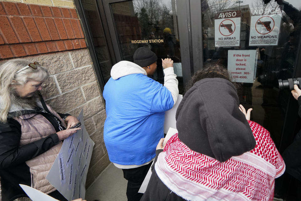 A group of demonstrators knock on a locked entrance as they protest outside a police precinct in response to the death of Tyre Nichols, who died after being beaten by Memphis police officers, in Memphis, Tenn., Sunday, Jan. 29, 2023. (AP Photo/Gerald Herbert)