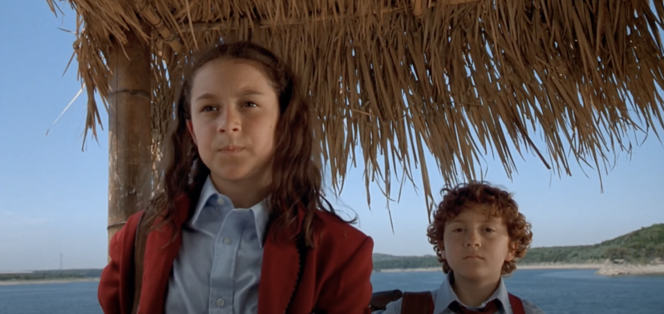 two school kids in a beach setting