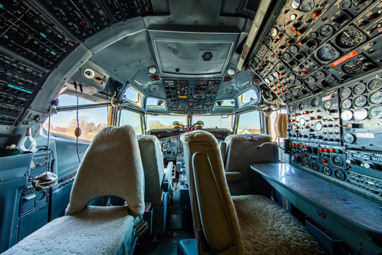 The 727 cockpit with fur-covered cockpit chairs.