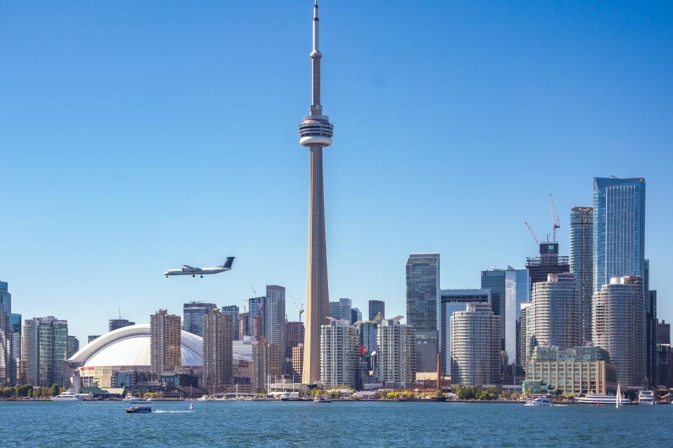 Skyline of Toronto, Canada with airplane.