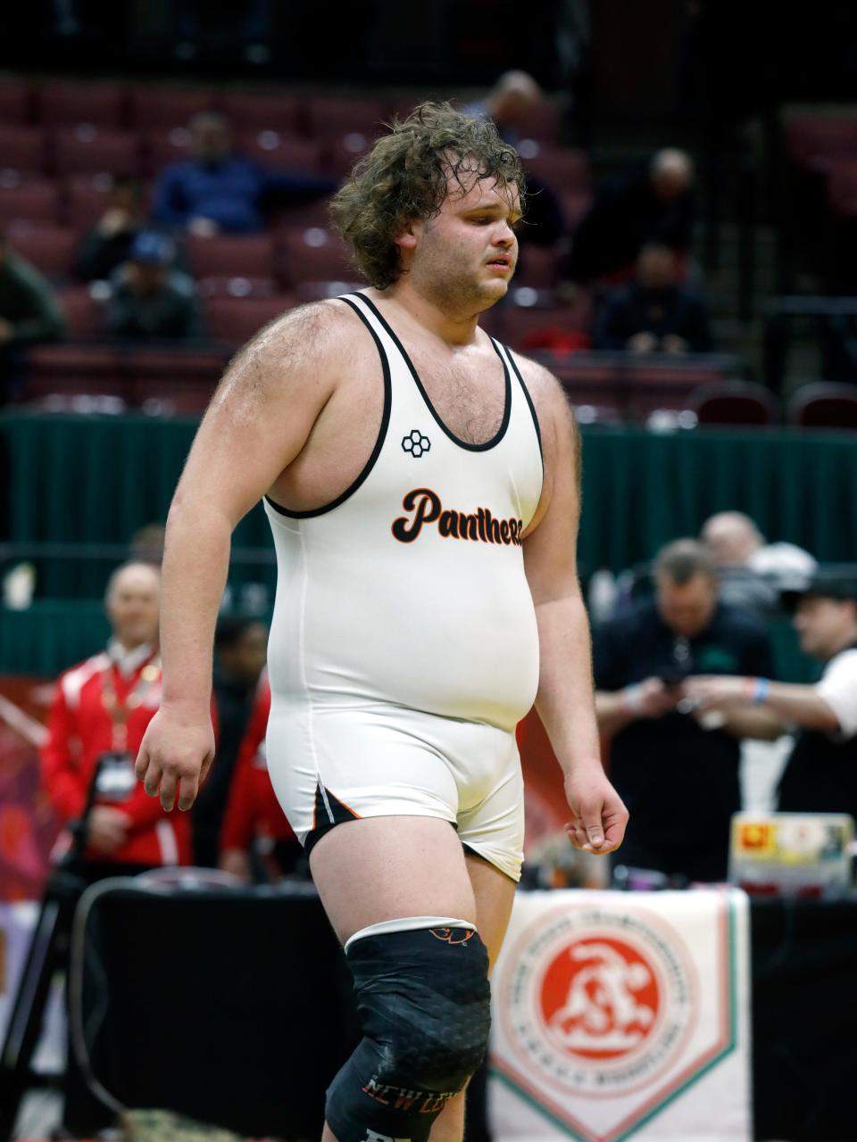 Zane Pletcher, of New Lexington, walks off the mat following a 2-1 double overtime loss to Circleville's Trentt Fulgam in the finals at 285 pounds during the Division II state tournament on March 12, 2023, at Ohio State's Value City Arena.