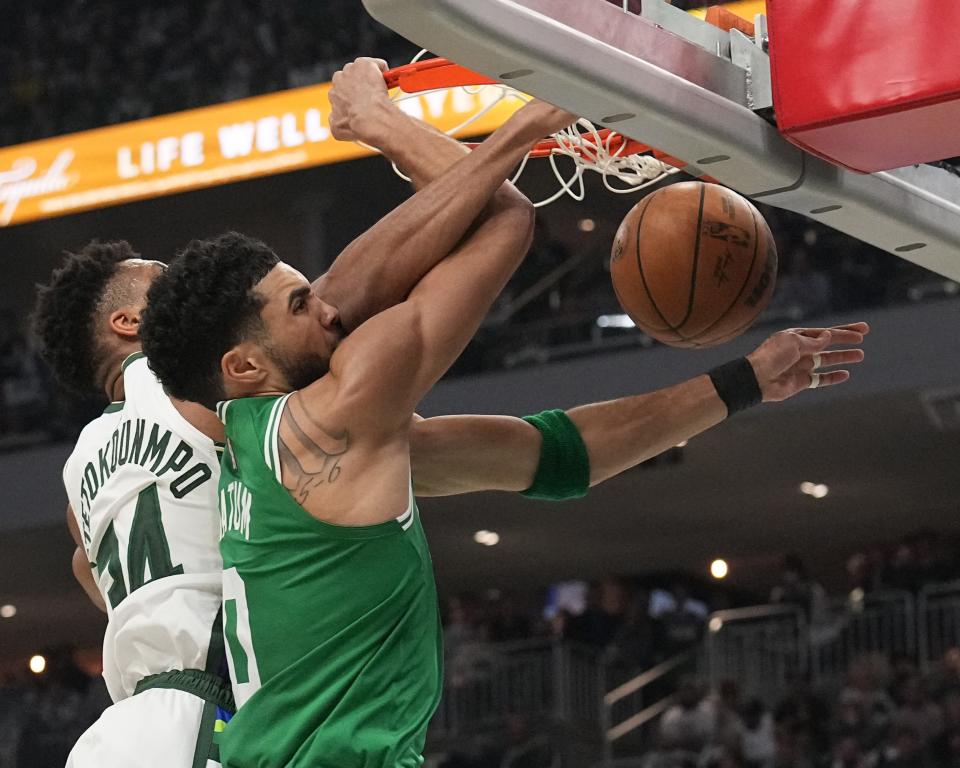 Giannis Antetokounmpo fouls Celtics forward Jayson Tatum during the first half Saturday at Fiserv Forum.