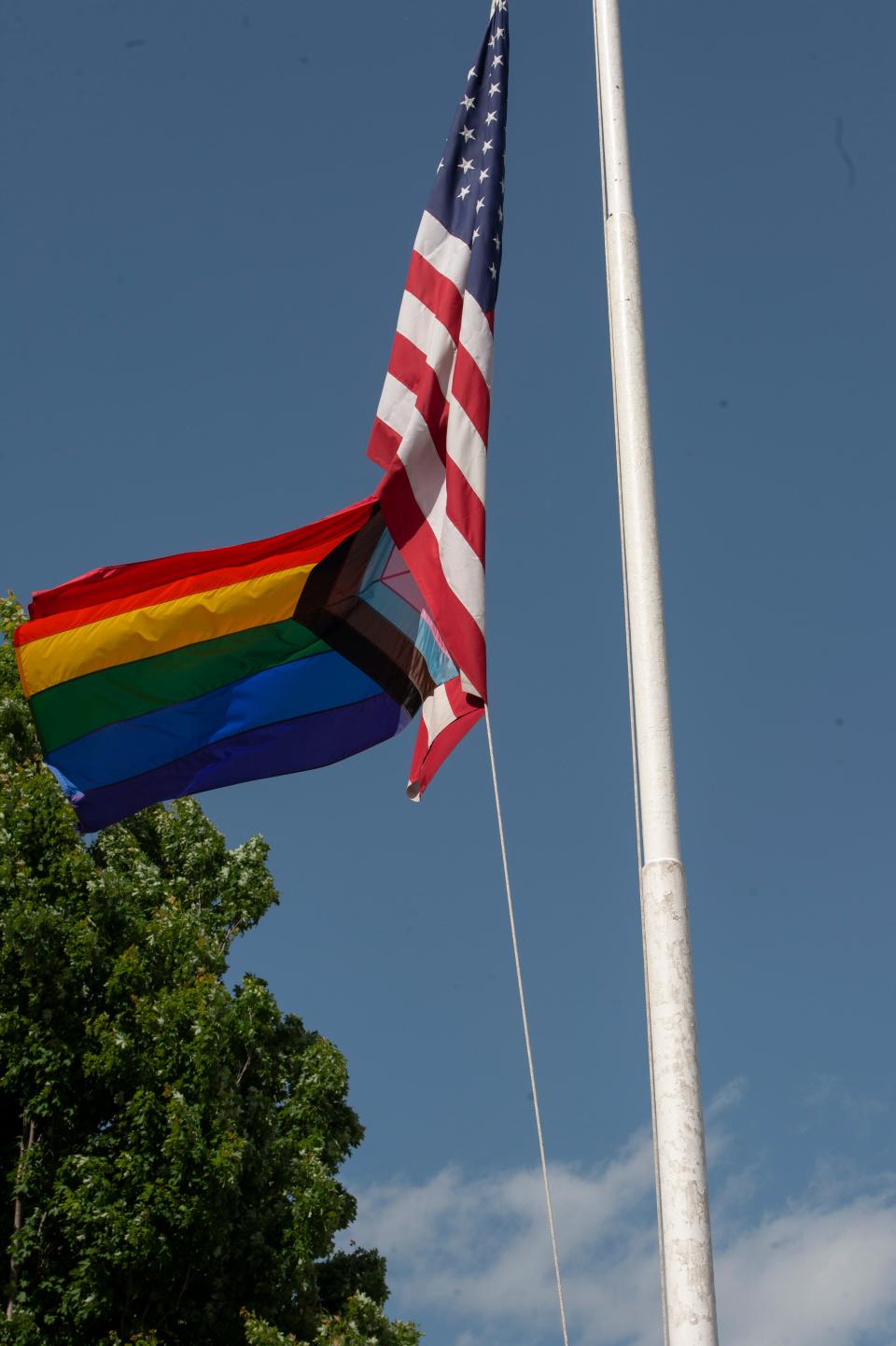 The redesigned Progress Pride flag flies outside the Memorial Building during the 4th annual Pride Ceremony in Framingham, June 4, 2022. The City Council’s Ordinances and Rules subcommittee has voted to send to the full council a proposal to limit what flags the city can fly on public buildings unless the council approves otherwise.
