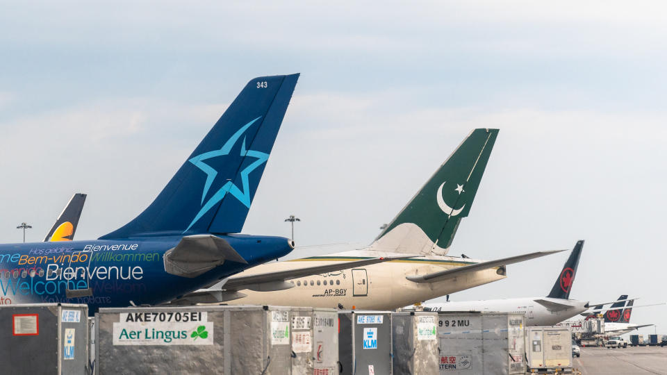Toronto, Ontario, Canada-April 15, 2019: Tail wings of diverse planes in Pearson International Airport. The one in the foreground belongs to Air Transat company. The second one belongs to the Pakistani national carrier. The rest at the background belong to Air Canada. Pearson Airport is one of the busiest transportation hubs in North America. The day time image has a slightly overcast sky