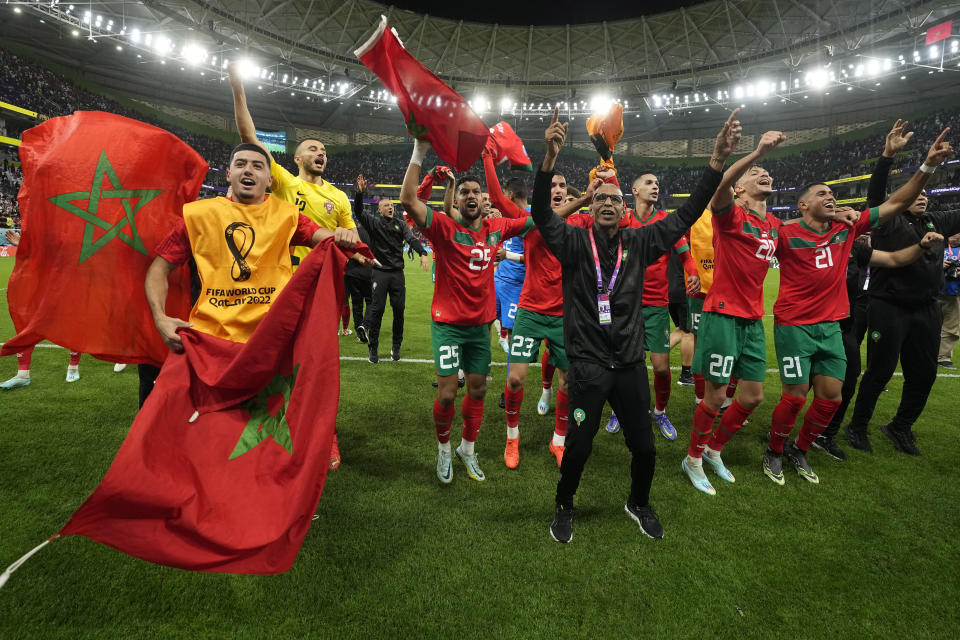 Morocco's players celebrate after the World Cup quarterfinal soccer match between Morocco and Portugal, at Al Thumama Stadium in Doha, Qatar, Saturday, Dec. 10, 2022. (AP Photo/Martin Meissner)