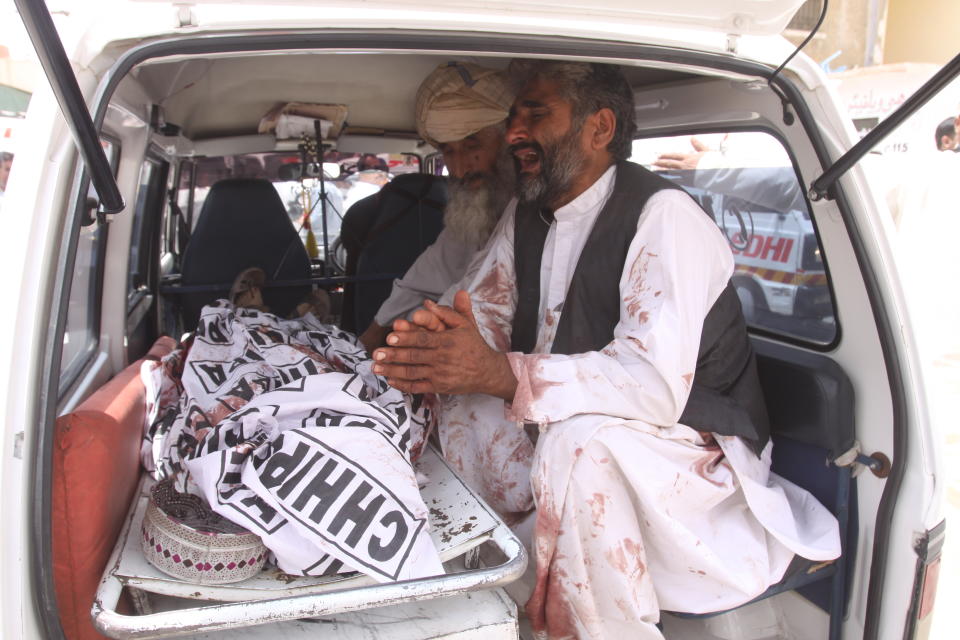 FILE - In this July 25, 2018, file photo, a man mourns the death of his family member at the site of a bombing in Quetta, Pakistan. A suicide bomber killed dozens of people as Pakistanis cast ballots in a general election. Counterterrorism department chief, Pervez Ahmed Chandio, said the Islamic State group is the newest and deadliest front in Pakistan's decades-old war on terror. "It is one of the most dangerous threats facing Pakistan and we are ready to fight this war," he said. (AP Photo/Arshad Butt, File)