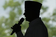 Presidential candidate Anies Baswedan is silhouetted as he speaks during a campaign rally in Lampung Timur, Indonesia, Sunday, Jan. 14, 2024. The former Jakarta governor seeking Indonesia's presidency said democracy is declining in the country and pledged to make changes to get it back on track. (AP Photo/Achmad Ibrahim)