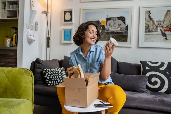 A woman opening a package. 