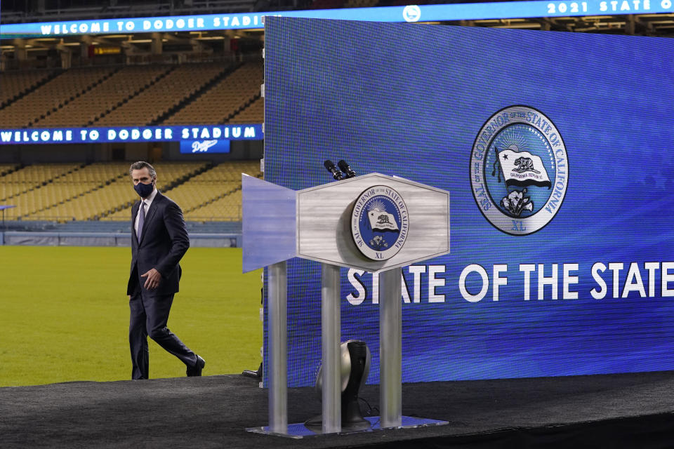 FILE - In this March 9, 2021, file photo, California Gov. Gavin Newsom approaches the stage to deliver his State of the State address from Dodger Stadium in Los Angeles. Gov. Newsom said he could have communicated better with the public last year before the first loosening of coronavirus restrictions that led to an early summer spike in case, a moment the called a "gateway that we reflect upon all the time" as the nation's most populous state enters the second year of pandemic restrictions. (AP Photo/Mark J. Terrill, File)