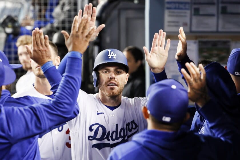 Los Angeles, CA - April 14: Los Angeles Dodgers first baseman Freddie Freeman (5) celebrates with the dugout after scoring on an RBI-single by Trea Turner during the eighth inning against the Cincinnati Reds at Dodger Stadium on Thursday, April 14, 2022 in Los Angeles, CA.(Robert Gauthier / Los Angeles Times)