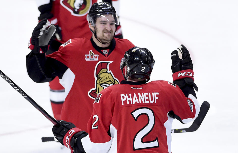 Ottawa Senators defenseman Dion Phaneuf (2) is congratulated by teammate Ottawa Senators right wing Mark Stone (61) on his goal during overtime of game two NHL Stanley Cup hockey playoff action against the Boston Bruins, in Ottawa, Saturday, April 15, 2017. (Sean Kilpatrick/The Canadian Press via AP)