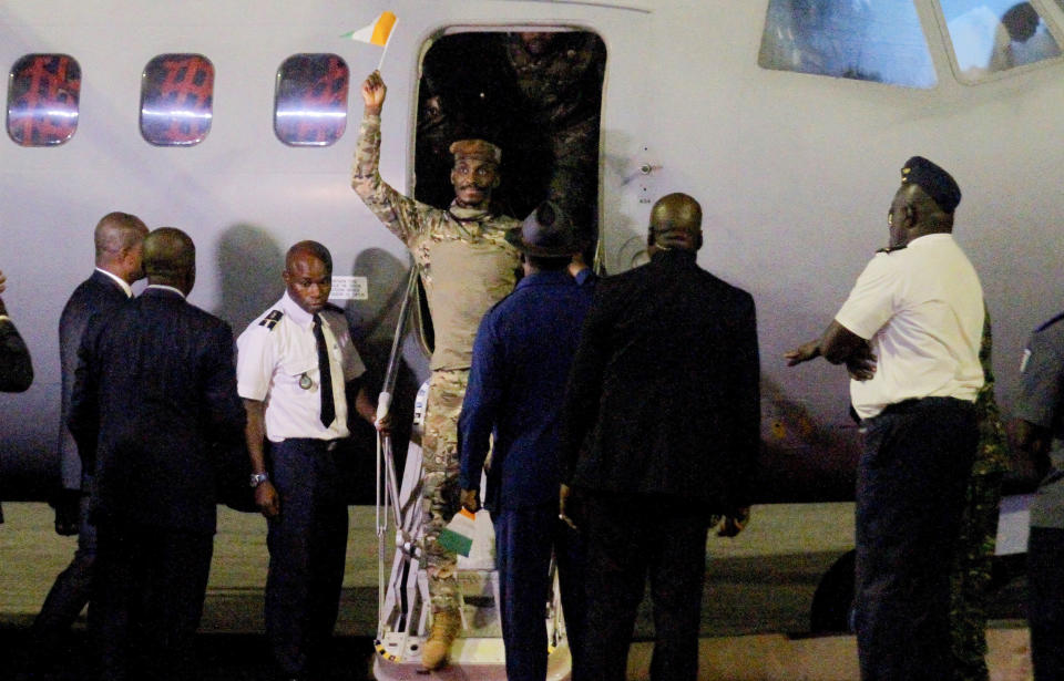 One of the soldiers from Ivory Coast who were convicted of undermining Mali's state security and conspiracy against the government and were pardoned by Mali's military junta leader gestures as they arrive in Abidjan, Ivory Coast, late Saturday Jan. 7, 2023. In a statement Friday, the junta's spokesman said junta leader, Col. Assimi Goita, granted the pardon and “demonstrates once again his commitment to peace, dialogue, pan-Africanism, and the preservation of fraternal and secular relations with the countries of the region, in particular those between Mali and Ivory Coast." (AP Photo/ Diomande Ble Blonde)