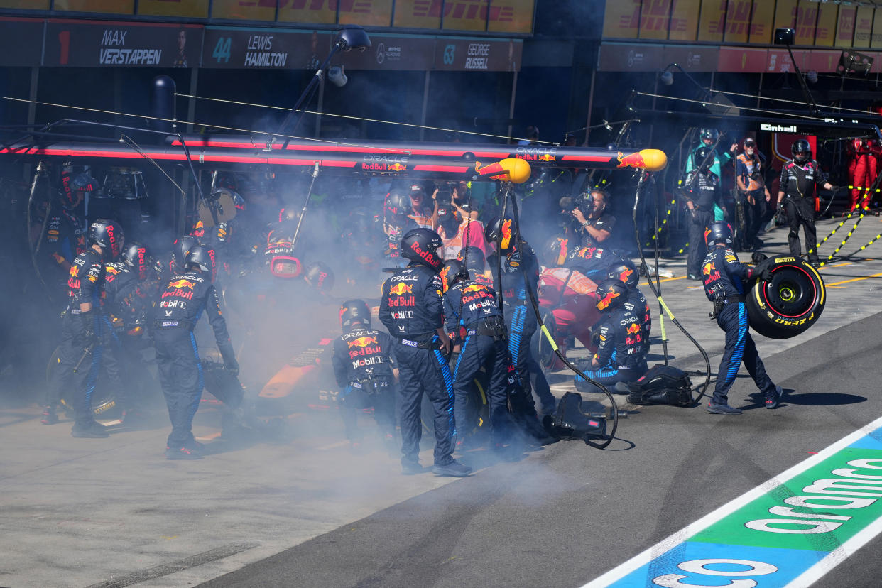 Mechanics deal with the smoke coming out of Red Bull Racing's Dutch driver Max Verstappen car during the Australian Formula One Grand Prix at Albert Park Circuit in Melbourne on March 24, 2024. (Photo by Scott Barbour / POOL / AFP) / -- IMAGE RESTRICTED TO EDITORIAL USE - STRICTLY NO COMMERCIAL USE -- (Photo by SCOTT BARBOUR/POOL/AFP via Getty Images)