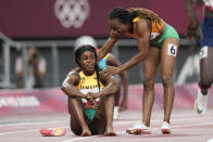 Elaine Thompson-Herah, of Jamaica, is congratulated by Marie-Josee Ta Lou, of Ivory Coast, after winning the final of the women's 200-meters at the 2020 Summer Olympics, Tuesday, Aug. 3, 2021, in Tokyo. (AP Photo/David Goldman)