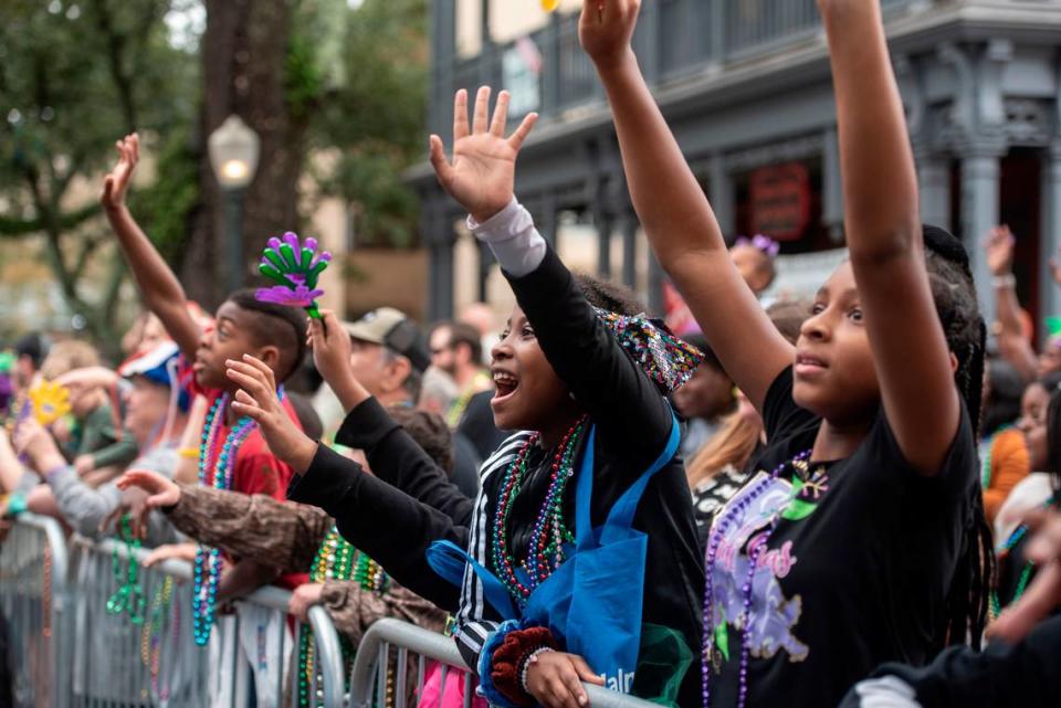 Parade attendees cheer for beads during The Ocean Springs Elks Carnival Parade in downtown Ocean Springs on Saturday, Jan. 27, 2024. Hannah Ruhoff/Sun Herald