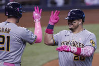 Milwaukee Brewers' Daniel Vogelbach (20) signals to Travis Shaw (21) after hitting a solo home run in the fourth inning of a baseball game against the Miami Marlins, Sunday, May 9, 2021, in Miami. (AP Photo/Marta Lavandier)