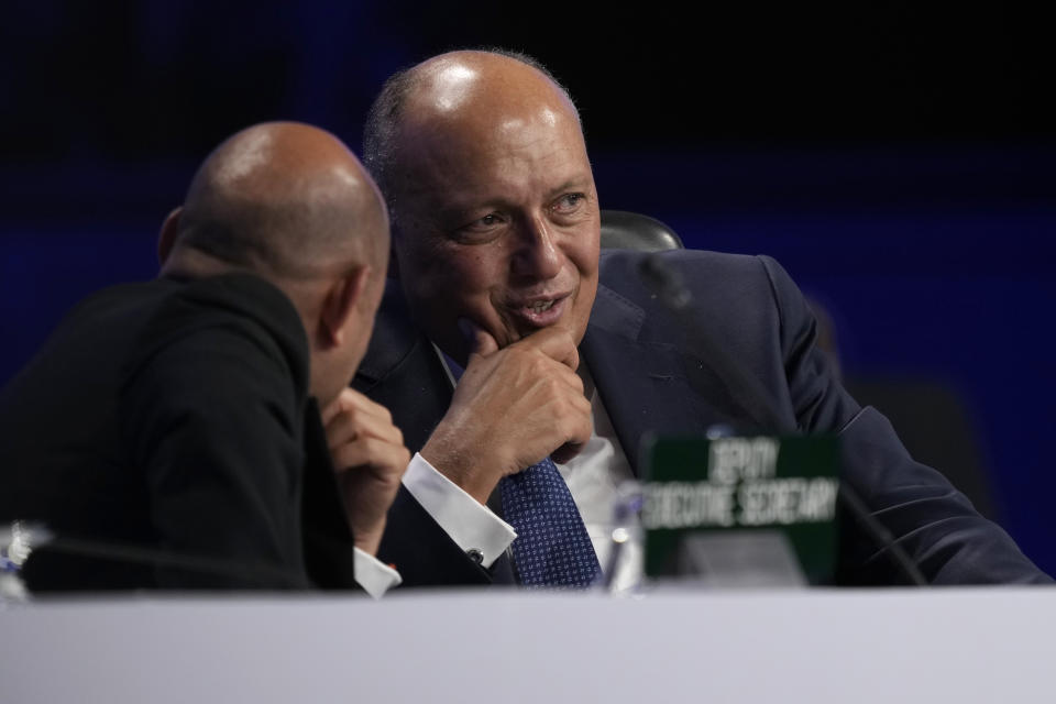 Sameh Shoukry, president of the COP27 climate summit, right, talks with Simon Stiell, U.N. climate chief, during a break in a closing plenary session at the U.N. Climate Summit, Sunday, Nov. 20, 2022, in Sharm el-Sheikh, Egypt. (AP Photo/Peter Dejong)