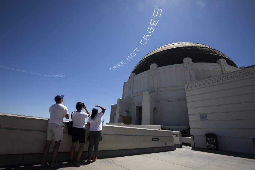 "CARE NOT CAGES," a skytyped message created by artist Patrisse Cullors, is visible from Griffith Park on July 3.