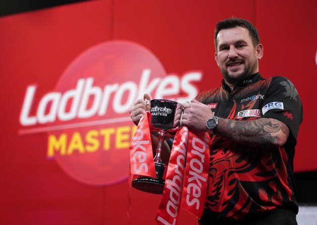 Jonny Clayton poses with the 2021 Ladbrokes Masters trophy