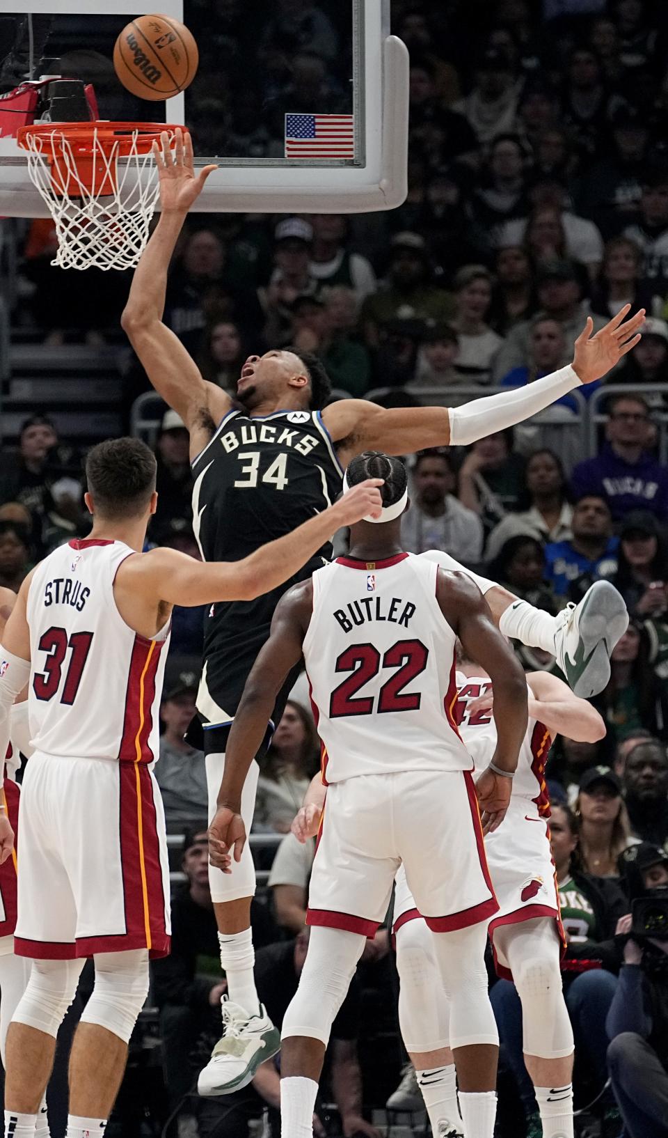 Bucks forward Giannis Antetokounmpo loses his balance as he is fouled on a drive against the Heat during the first quarter Monday. Giannis suffered a back contusion on the play and eventually left Game 1 of the first round playoff series for good in the second quarter.