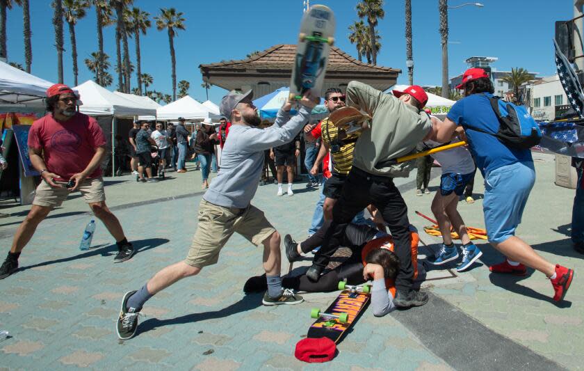 Skateboarders clash with demonstrators gathered in support of Trump at Huntington Beach Pier on Saturday, April 1.