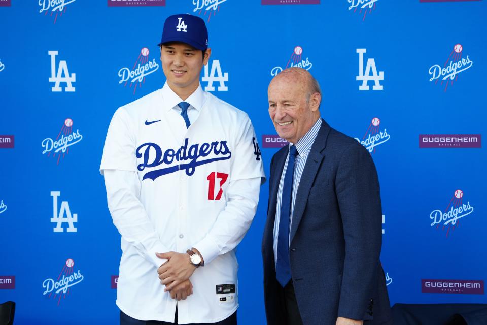 Shohei Ohtani poses with Stan Kasten at his introductory press conference in December.