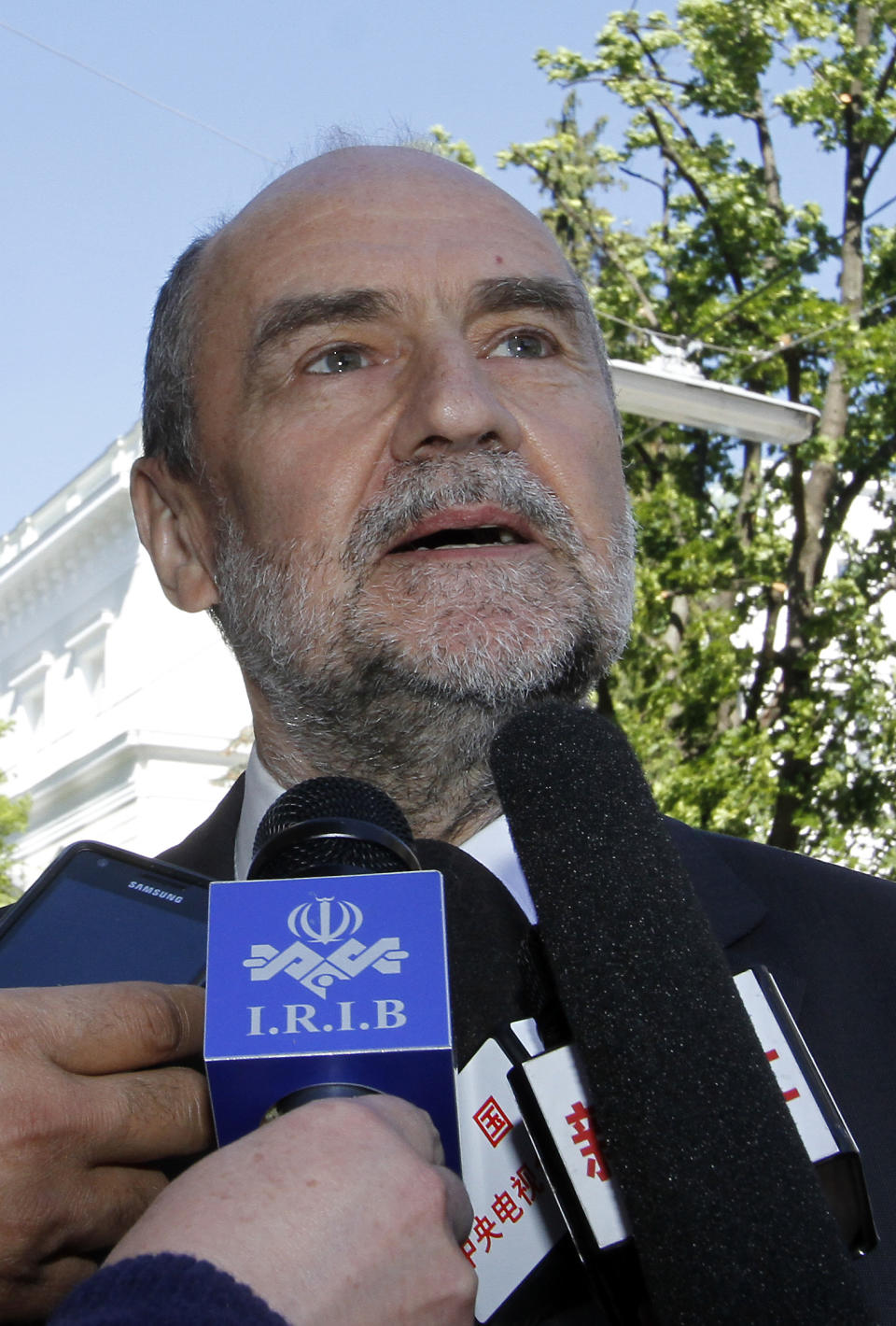 Herman Nackaerts, Deputy Director General and Head of the Department of Safeguards of the International Atomic Energy Agency, IAEA, speaks to media as he arrives for talks with the Iran at the permanent mission of Iran in Vienna, Austria, Wednesday, May 15, 2013. U.N. nuclear agency officials are meeting with Iranian counterparts in a renewed attempt by the agency to re-launch its probe of suspicions that Tehran might have worked on atomic arms. (AP Photo/Ronald Zak)