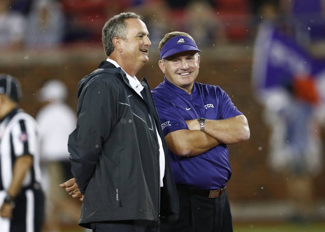 TCU coach Gary Patterson, right, and SMU coach Sonny Dykes, left, talk before an NCAA college football game Friday, Sept. 7, 2018, in Dallas. Jim Cowsert/AP