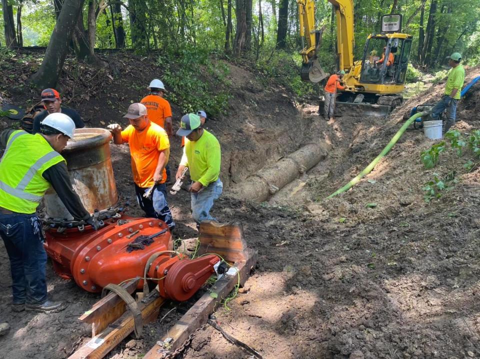 Crews with Dominion Construction Co. work to repair a water and sewer main near the Bryant Bridge over the Black Warrior River in Tuscaloosa, Ala.