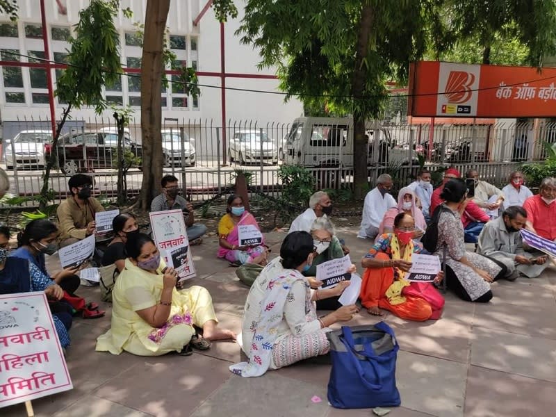 People sit in protest demanding action against the four men accused of raping and killing a nine-year-old. Image credit: Twitter/ DYFI