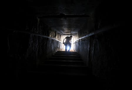 A man walks out of a passage from inside the Bent Pyramid of Sneferu that was reopened after restoration work, in Dahshur, south of Cairo