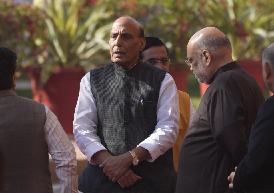 Indian Defence Minister Rajnath Singh, center, and Home Minister Amit Shah, right, talk to their cabinet colleagues as they wait to pay respect to the victims of 2001 terror attack on Parliament House, in New Delhi, Tuesday, Dec. 13, 2022. Soldiers from India and China clashed last week along their disputed border, India's defense minister said Tuesday, marking yet another serious face-off along the contested frontier since June 2020 when troops from the two rival countries were killed in a deadly brawl. (AP Photo/Manish Swarup)