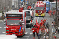 Olympic sponsors' vehicles parade ahead of torch relay on March 28, 2021, in Ashikaga, Tochigi prefecture, north of Tokyo. Now, nothing is certain as Tokyo's postponed Olympics hit the 100-days-to-go mark on Wednesday, April 14, 2021. (Shinji Kita/Kyodo News via AP)