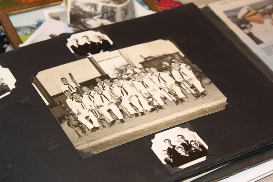 A photo album in the home of Pearl Harbor survivor Ira “Ike” Schab in Beaverton, Ore. on Monday, Nov. 20, 2023, shows an old group photo of the U.S. Navy Band. Schab, now 103, played tuba in the band and remained close with his bandmates for decades after the war. Schab plans to return to Pearl Harbor for the 82nd anniversary of the attack to remember the more than 2,300 servicemen killed. (AP Photo/Claire Rush)