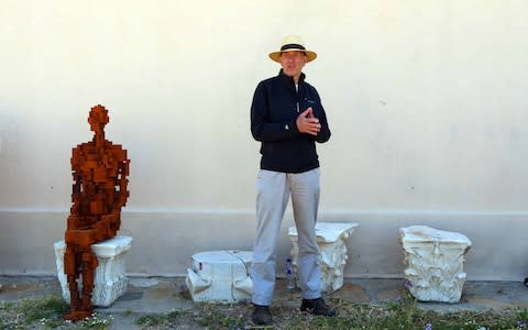 Antony Gormley with one his sculptures on Delos - Credit: Xinhua News Agency / eyevine