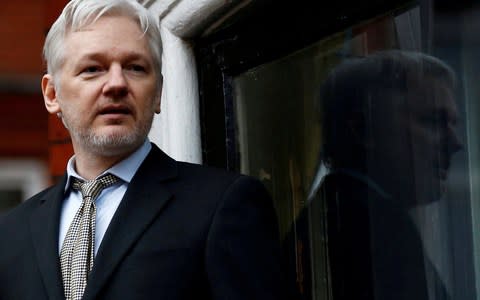 Julian Assange, the WikiLeaks founder, makes a speech from the balcony of the Ecuadorian Embassy, in central London - Credit: REUTERS/Peter Nicholls