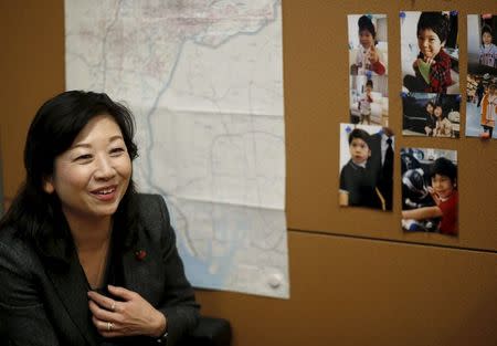 Seiko Noda, a former cabinet minister and Liberal Democratic Party (LDP) policy chief, speaks next to photos of her son during an interview with Reuters at her office in Tokyo, Japan, December 21, 2015. REUTERS/Toru Hanai