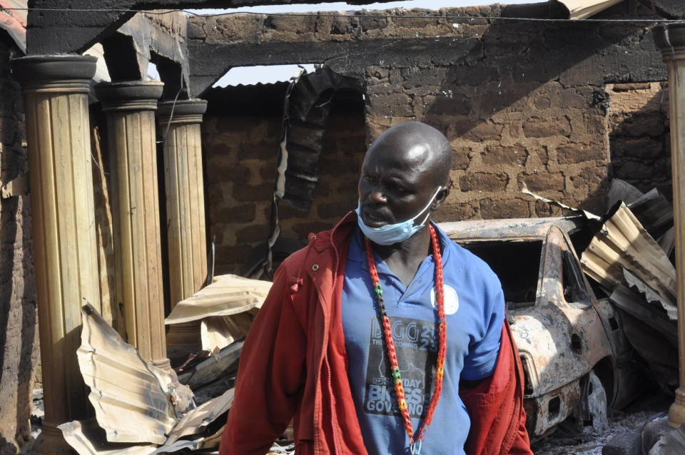 A man stands in front of a burnt out house following an attacked by gunmen in, Bokkos, north central Nigeria, Tuesday, Dec. 26, 2023. Nigerian officials and survivors say at least 140 people were killed by gunmen who attacked remote villages in north-central Nigeria's Plateau state in the latest of such mass killings this year blamed on the West African nation's farmer-herder crisis. (AP Photo)