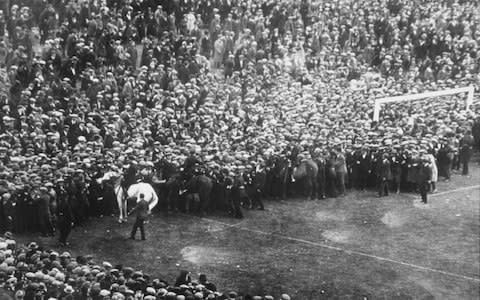 Police clear fans off of the pitch during the famous White Horse FA Cup Final between Bolton and West Ham at Wembley Stadium - Credit: Allsport Hulton Getty/ALLSPORT