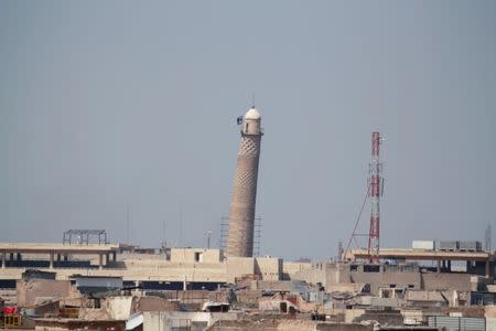 A flag of Islamic State militants is seen on top of Mosul's Al-Hadba minaret at the Grand Mosque, where Islamic State leader Abu Bakr al-Baghdadi declared his caliphate back in 2014, during clashes between Iraqi forces and Islamic State militants in Mosul, Iraq, March 24, 2017. Picture taken March 24, 2017. REUTERS/Khalid al Mousily