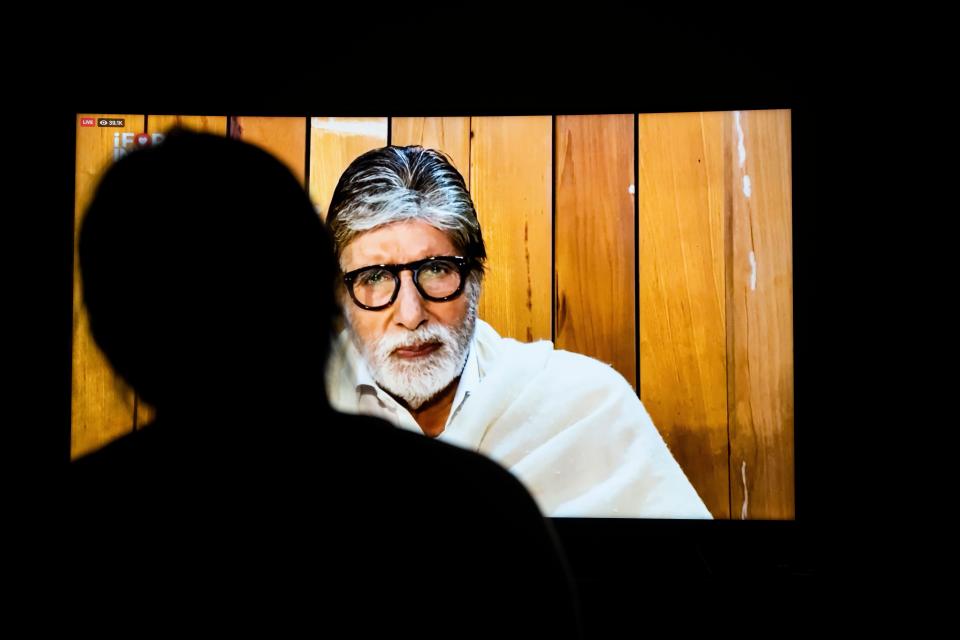 A woman watches Bollywood actor Amitabh Bachchan speaking during the 'I For India' concert live on Facebook on a television screen in New Delhi on May 3, 2020. - International and Bollywood stars took part in a four-hour online concert on May 3 to raise funds for the battle against coronavirus in India, where the number of cases is surging. (Photo by Jewel SAMAD / AFP) (Photo by JEWEL SAMAD/AFP via Getty Images) / Credit: JEWEL SAMAD