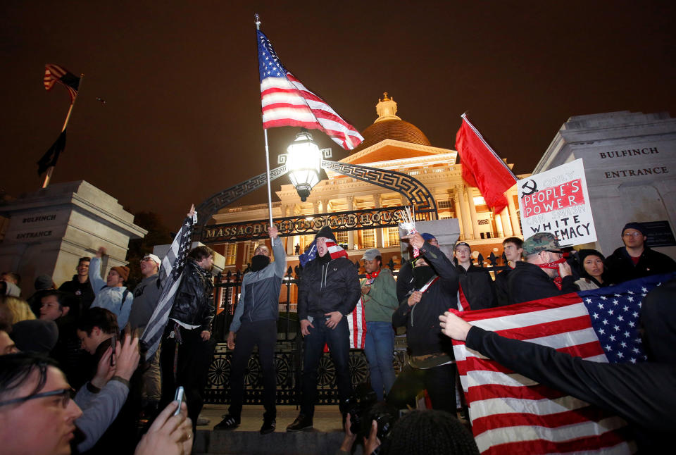 Protesters stand on the state house steps during a march in opposition to the election of Republican Donald Trump as President of the United States in Boston